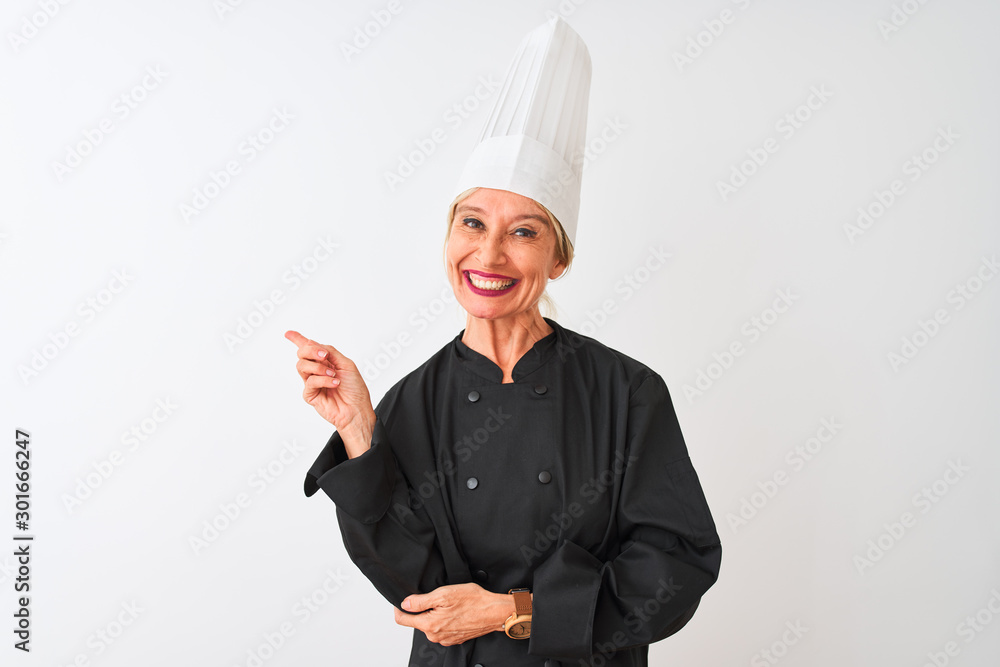 Middle age chef woman wearing uniform and hat standing over isolated white background with a big smile on face, pointing with hand and finger to the side looking at the camera. Middle age chef woman wearing uniform and hat standing over isolated white background with a big smile on face, pointing with hand and finger to the side looking at the camera.