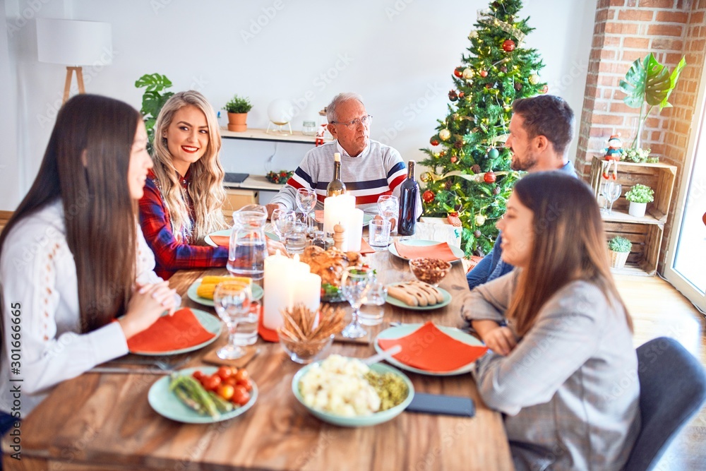 Beautiful family meeting smiling happy and confident. Eating roasted turkey celebrating Christmas at home