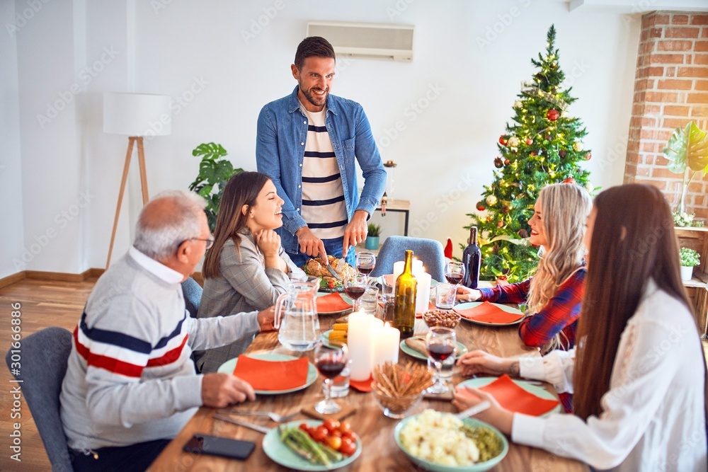 Beautiful family meeting smiling happy and confident. Carving roasted turkey celebrating Christmas at home Beautiful family meeting smiling happy and confident. Carving roasted turkey celebrating Christmas at home