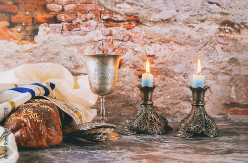 Sabbath Jewish Holiday challah bread and candelas on wooden table photo