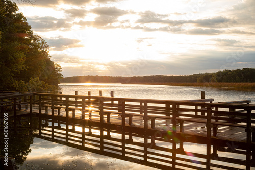 Boardwalk at Sunrise at High Tide with Sun and Clouds
