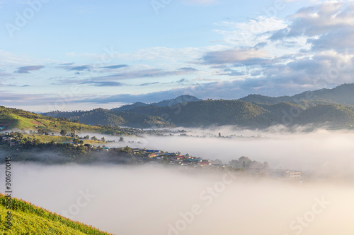 panorama image.View of village covered in foggy during morning sunrise colorful sky