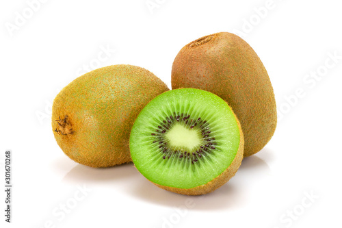 Fresh whole kiwi fruit and cut in half sliced isolated on white background. Full depth of field.
