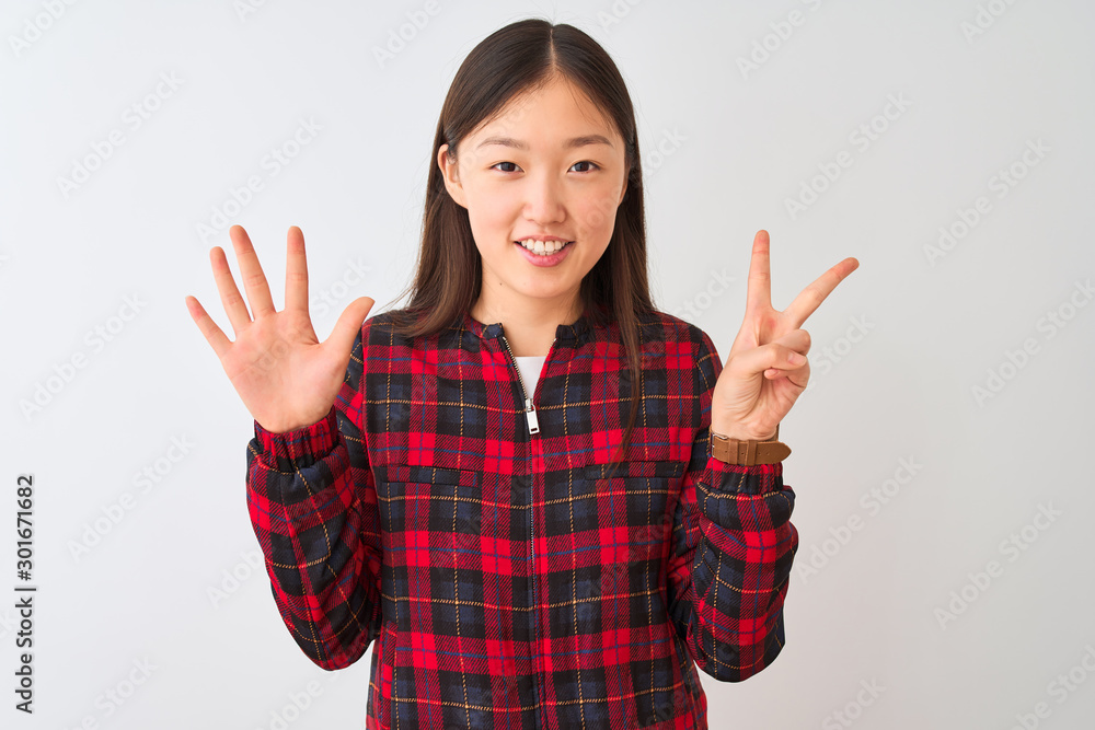 Young chinese woman wearing casual jacket standing over isolated white background showing and pointing up with fingers number seven while smiling confident and happy. Young chinese woman wearing casual jacket standing over isolated white background showing and pointing up with fingers number seven while smiling confident and happy.