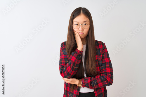 Young chinese woman wearing casual jacket and glasses over isolated white background thinking looking tired and bored with depression problems with crossed arms. © Krakenimages.com