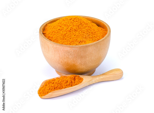 Turmeric or tumeric powder ( known as curcumin, Curcuma longa Linn) in wooden bowl and spoon isolated on white background. Full depth of field with clipping path. Natural herbal plant concept. 
