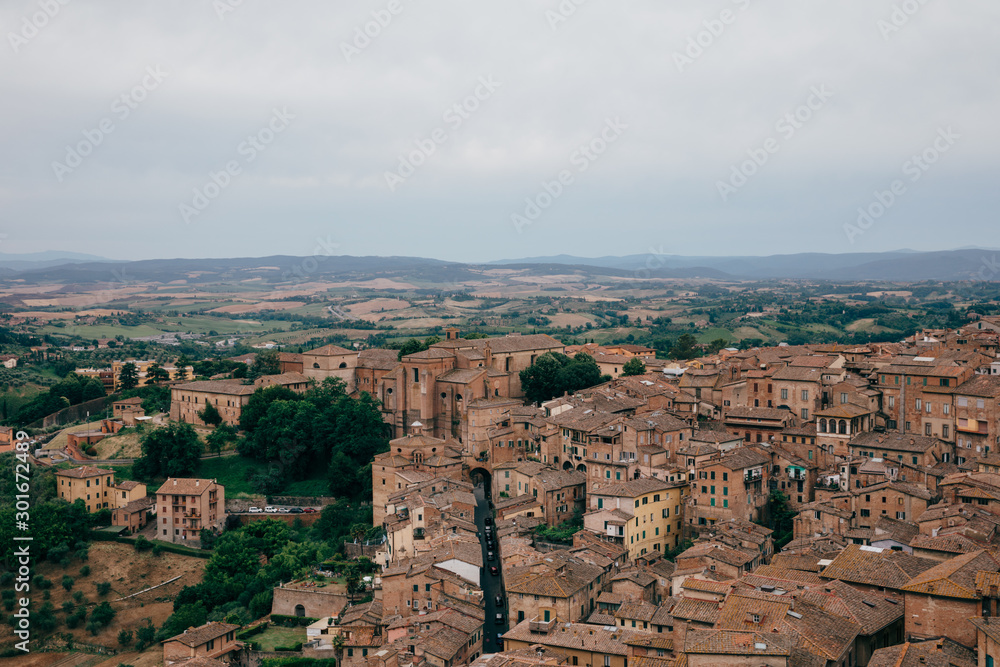 Fototapeta premium Panoramic view of Siena city with historic buildings and streets