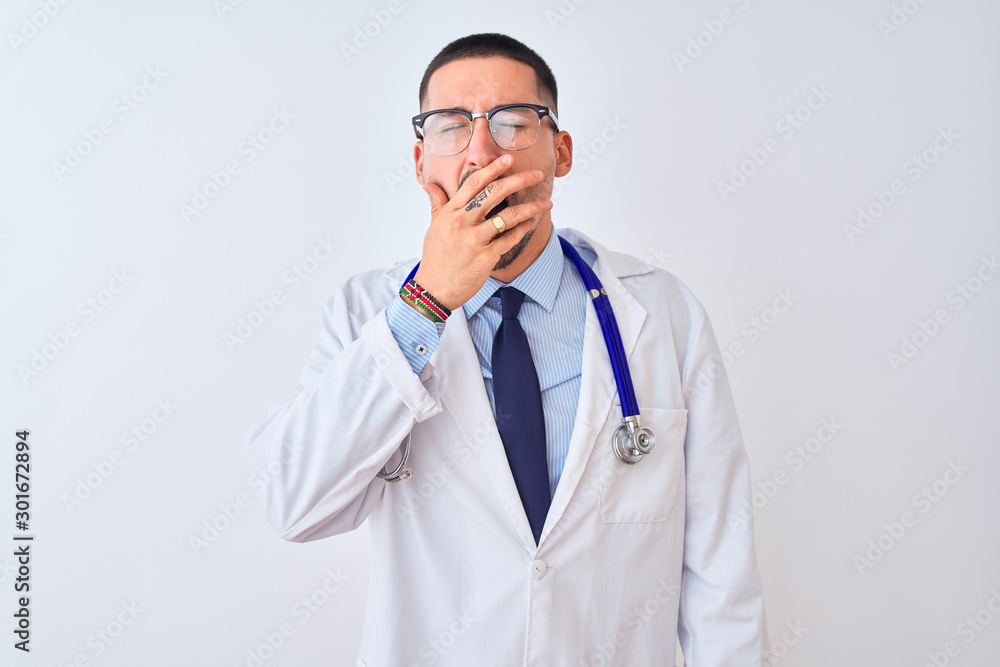 Young doctor man wearing stethoscope over isolated background bored yawning tired covering mouth with hand. Restless and sleepiness.