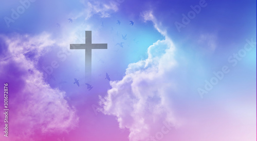 Christian cross appeared bright in the sky with soft fluffy clouds, white, beautiful colors. With the light shining as hope, love and freedom in the sky background © Ping198