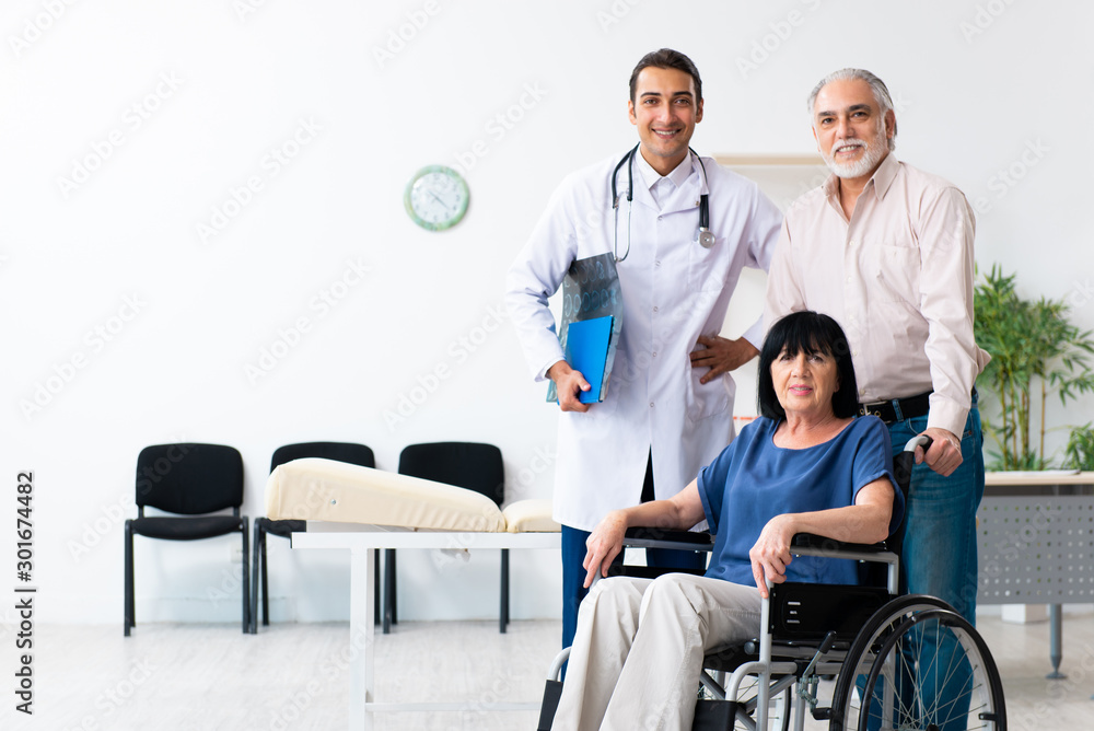 Old couple visiting young male doctor
