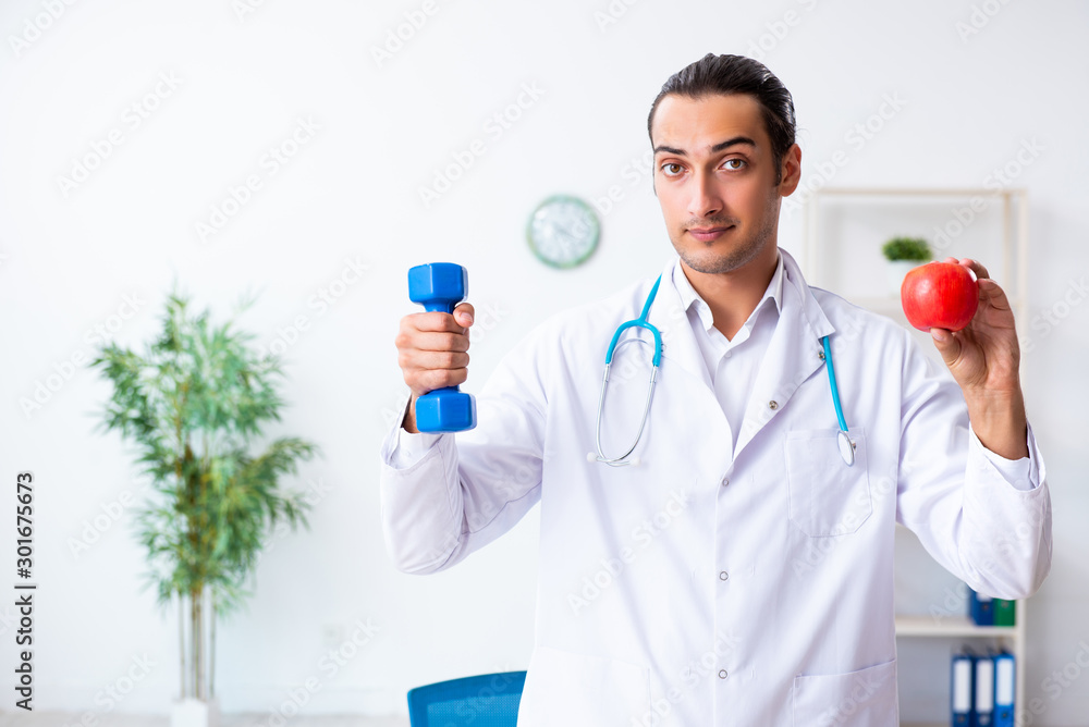 Young male doctor in sport and dieting concept Young male doctor in sport and dieting concept
