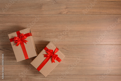 Gifts boxes with festive ribbons on wooden background
