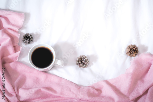 Christmas composition. Cup of coffee, scarf on pink background. Christmas, winter concept. Flat lay, top view, copy space