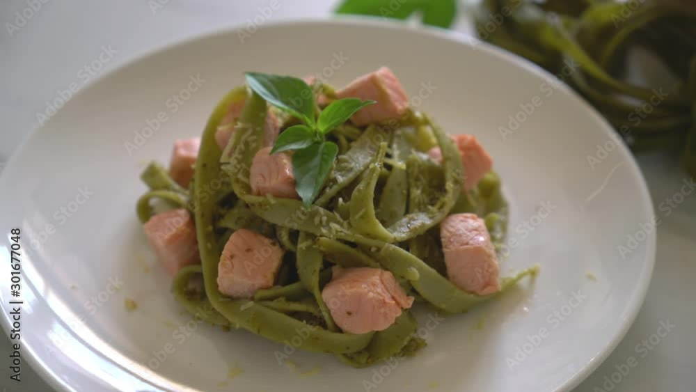 spinach fettuccine with salmon on plate with ingredients spinach fettuccine with salmon on plate with ingredients