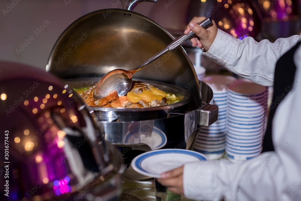 Naklejka premium Food Buffet Catering Dining Eating Party Sharing Concept.people group catering buffet food indoor in luxury restaurant with meat colorful fruits and vegetables