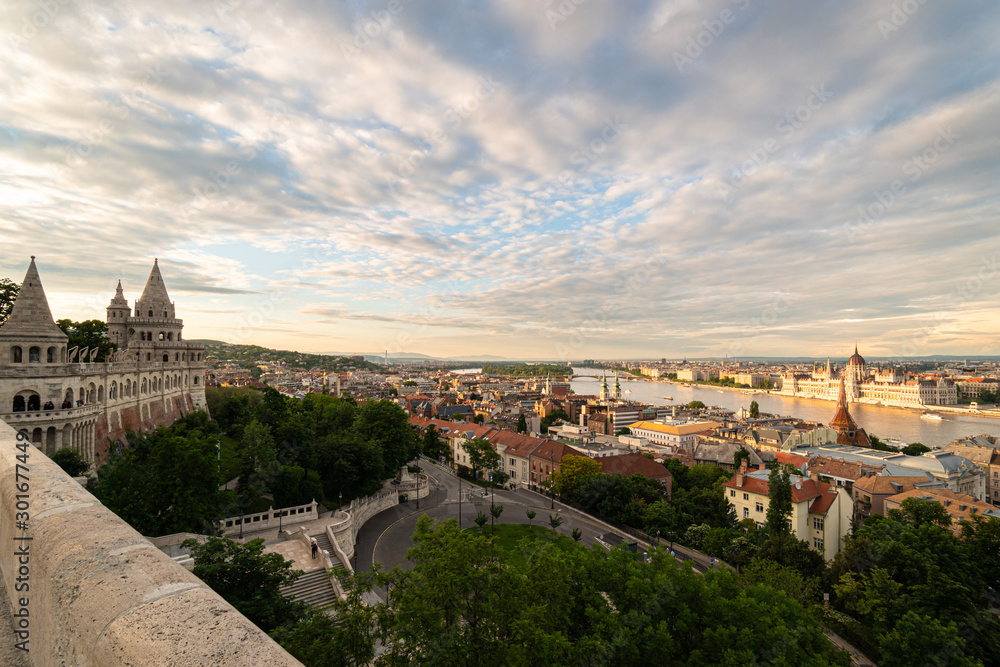 Sunset over the Fisherman's Bastion and the parliament house in Budapest by the Danube in Hungary capital city old town