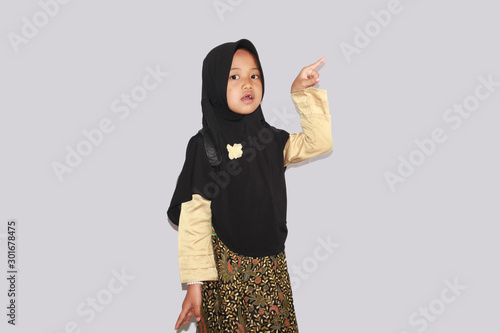 Portrait of cute A young asian little girl 6-7 years old muslim, wearing hijab, show face expression