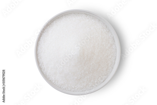 Closeup white sugar in white bowl isolated on white background with clipping path. Unhealthy diet ,awareness and stop diabetes concept. Top view. Flat lay'