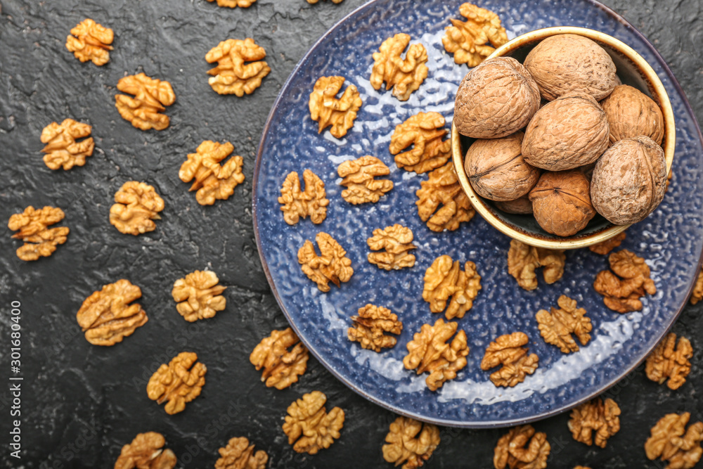 Composition with tasty walnuts on dark background Composition with tasty walnuts on dark background