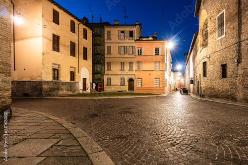 Night view of Parma old town house and cobblestone street in Itlay