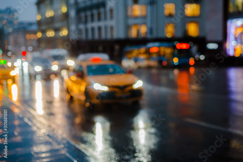 Wet night city street rain Bokeh reflection bright colorful lights puddles sidewalk Car © shangarey