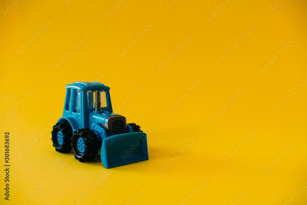 Fototapeta premium Toy blue agricultural tractor