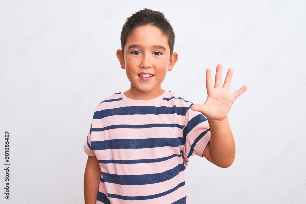 Beautiful kid boy wearing casual striped t-shirt standing over isolated white background showing and pointing up with fingers number five while smiling confident and happy. Beautiful kid boy wearing casual striped t-shirt standing over isolated white background showing and pointing up with fingers number five while smiling confident and happy.