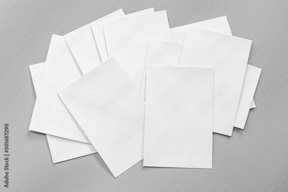 Poster mock-ups paper, white paper isolated on gray background with copy space for text, Blank portrait A4. brochure magazine isolated, can use banners products business cards to showcase your. Poster mock-ups paper, white paper isolated on gray background with copy space for text, Blank portrait A4. brochure magazine isolated, can use banners products business cards to showcase your.