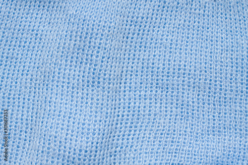 Knit stitch pattern. Soft blue woolen knitwear texture. 
