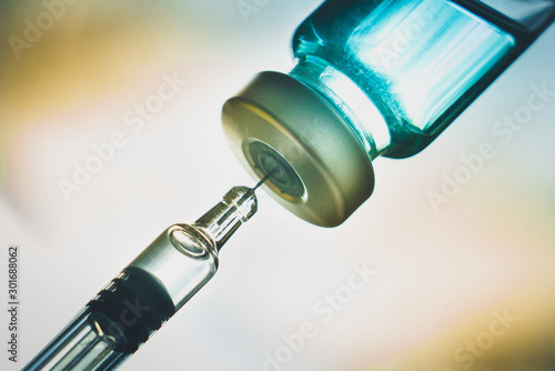 Close up of measles and flu vaccine vials for child vaccination, medicine and drug concept