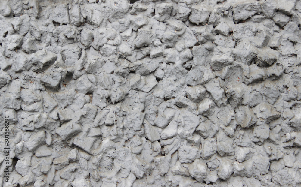 Closeup of a wall made of crushed stone and scrap brick plastered with cement Closeup of a wall made of crushed stone and scrap brick plastered with cement
