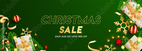 Green header or banner design decorated with gift boxes, baubles, snowflake, pine leaves, lighting garland and 70% discount offer for Christmas Sale.