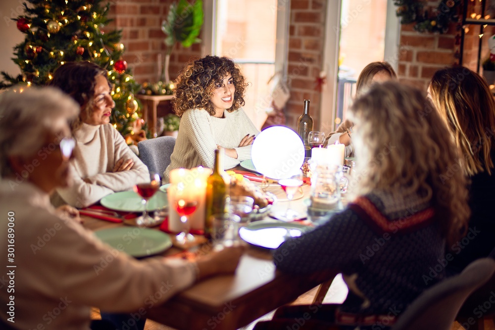 Beautiful group of women smiling happy and confident. Eating roasted turkey celebrating christmas at home Beautiful group of women smiling happy and confident. Eating roasted turkey celebrating christmas at home