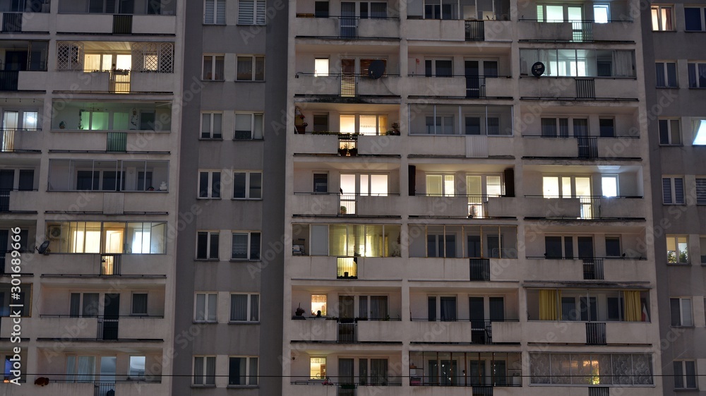 Exterior of apartment building at night with light from windows
