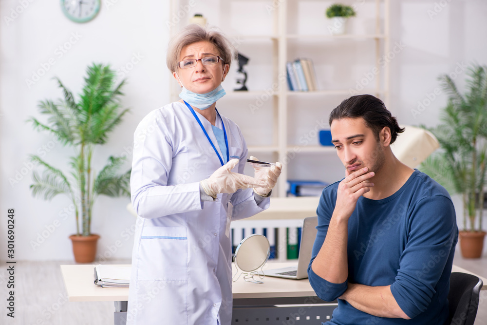 Fototapeta premium Young patient visiting doctor in hospital