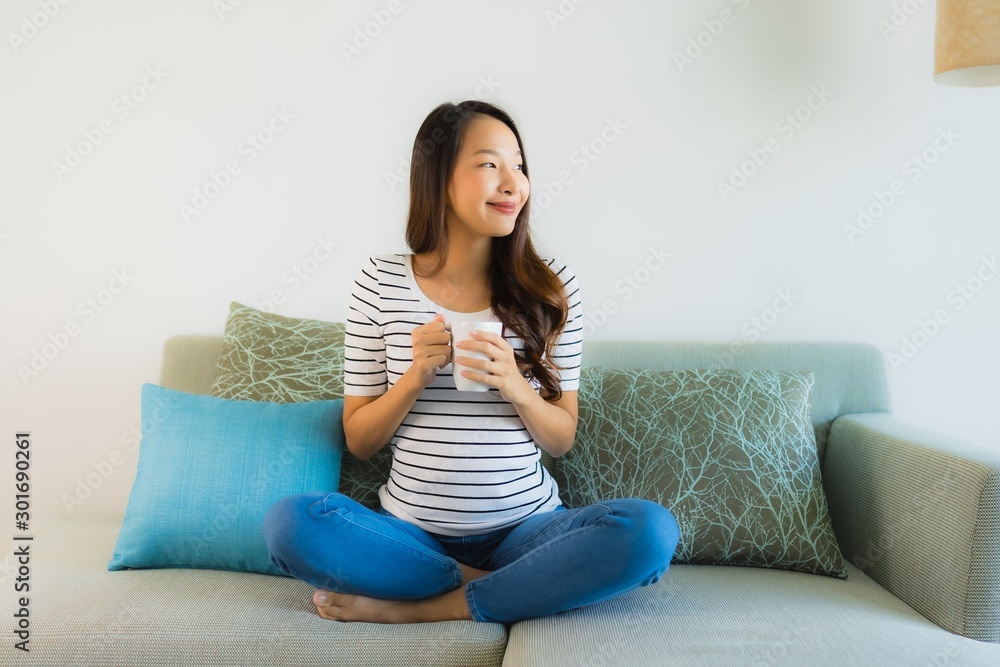 Portrait beautiful young asian woman on sofa with coffee cup Portrait beautiful young asian woman on sofa with coffee cup