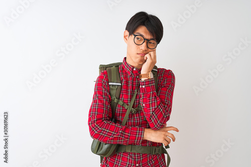 Chinese hiker man wearing backpack canteen glasses over isolated white background thinking looking tired and bored with depression problems with crossed arms.