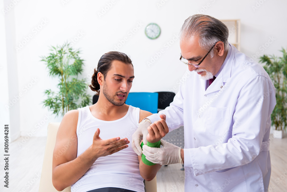 Young male patient visiting experienced doctor Young male patient visiting experienced doctor