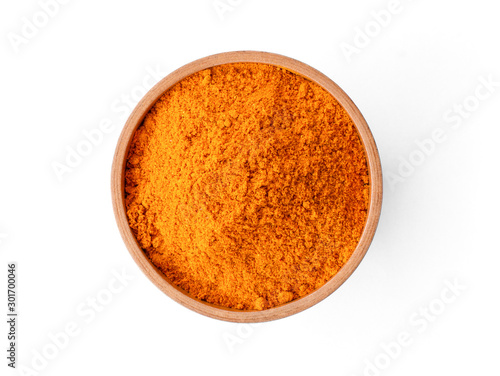 Closeup turmeric ( known as curcumin, Curcuma longa Linn) powder in wooden bowl isolated on white background with clipping path.Top view. Flat lay.