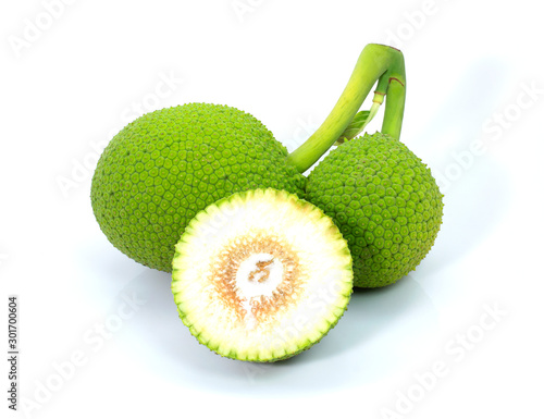 Close up heap of breadfruit (known as bread nut, Artocarpus altillis) and cut in half sliced isolated on white background . Natural herbal plant concept. photo