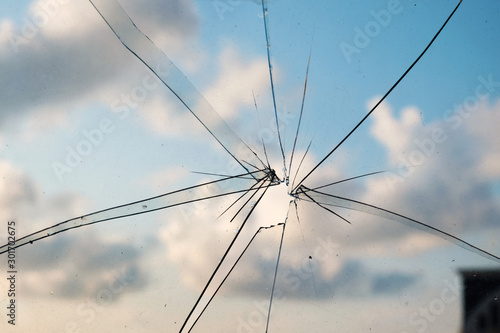 broken and cracked glass with hole