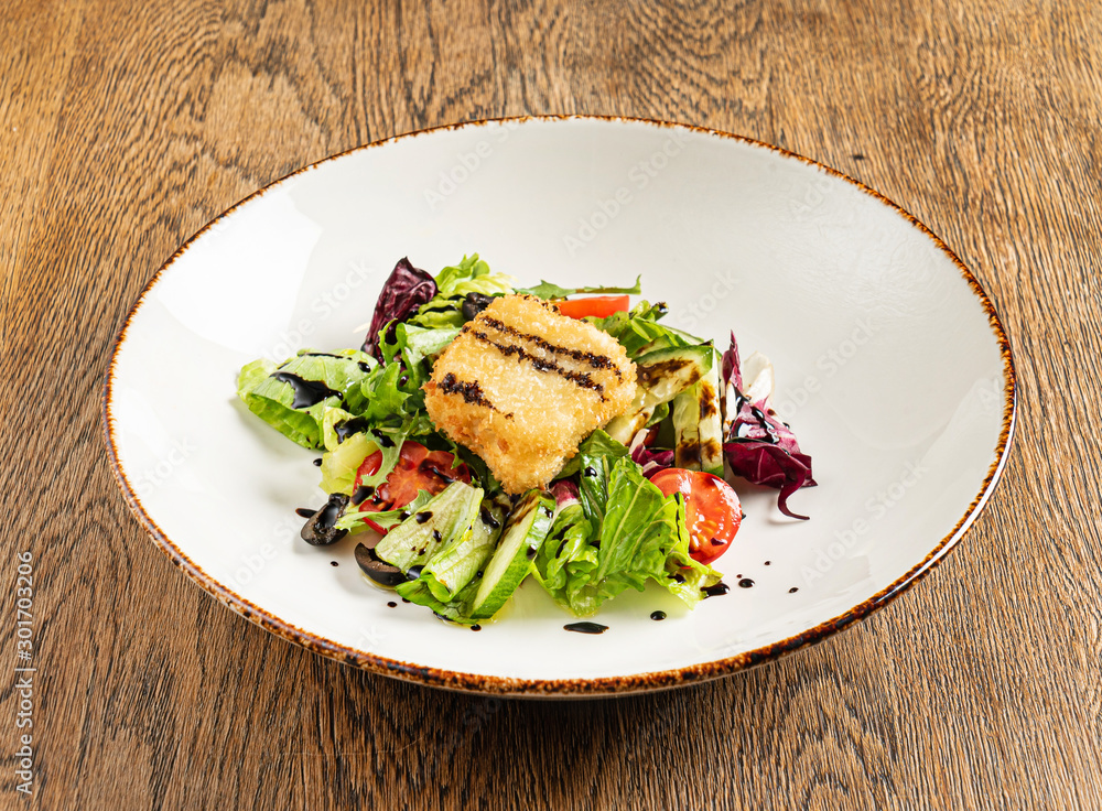 salad with fish on the wooden background salad with fish on the wooden background