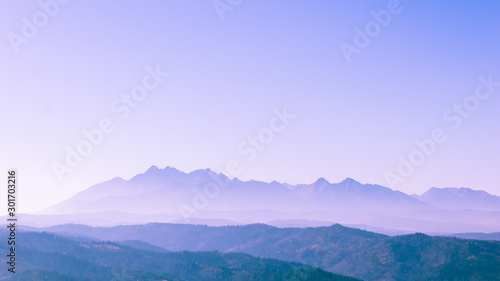 Surreal mountain landscape, purple neon pale mountains and sky, creative inspiration nature concept