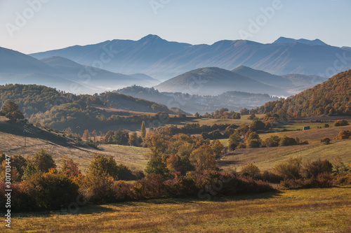 Morning view of Monteleone di Spoleto medieval village with fog on autumn day photo