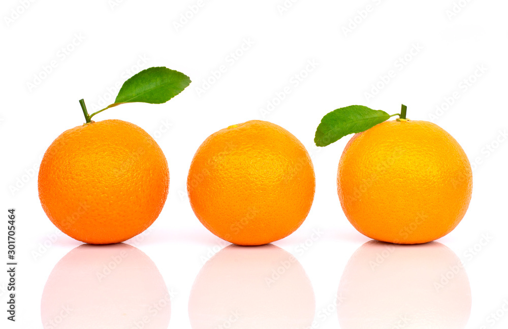 Closeup three whole ripe fresh orange fruits with green leaf isolated on white background with shadow. Closeup three whole ripe fresh orange fruits with green leaf isolated on white background with shadow.