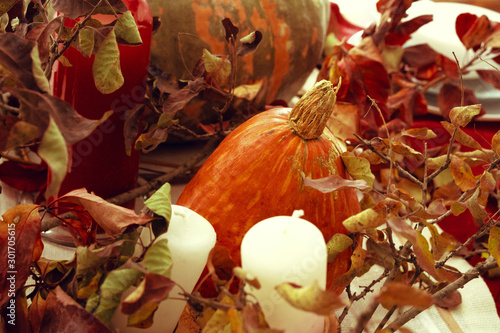 Stylish thanksgiving autumn table decor with pumpkin and dried branches