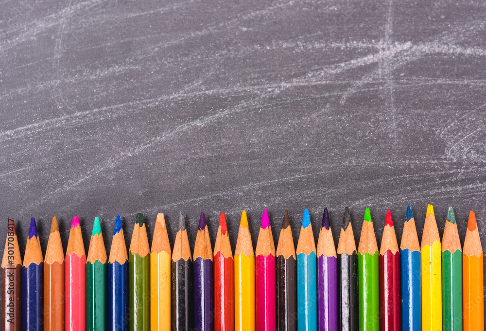 Multi Color pencils on crowd on blackboard and have chalkboard Multi Color pencils on crowd on blackboard and have chalkboard