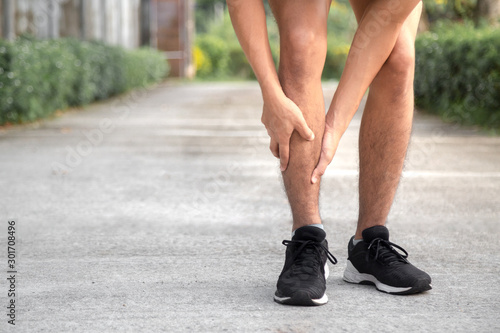 young runner is suffering from shin splints photo