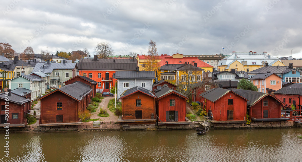 Porvoo town, Finland. Old red wooden houses on the river coast on a cloudy day