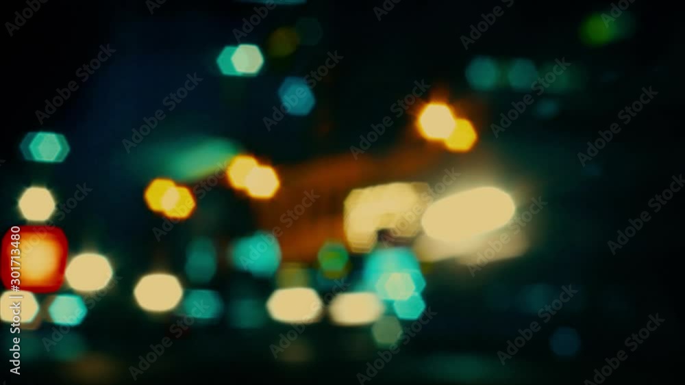 Abstract bokeh background in blue, white, yellow, green and orange colours. Night city blurred out of focus spot lights. Abstract bokeh background in blue, white, yellow, green and orange colours. Night city blurred out of focus spot lights.